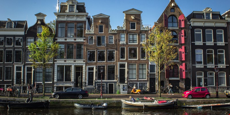 typical houses by a canal in the Jordaan neighbourhood in Amsterdam, the Netherlands