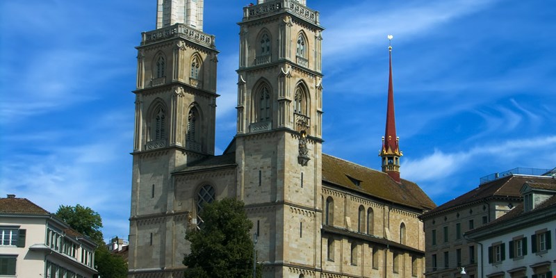 Grossmünster, Great minster church at the medieval old town at Swiss City of Zürich on a blue cloudy spring day.
